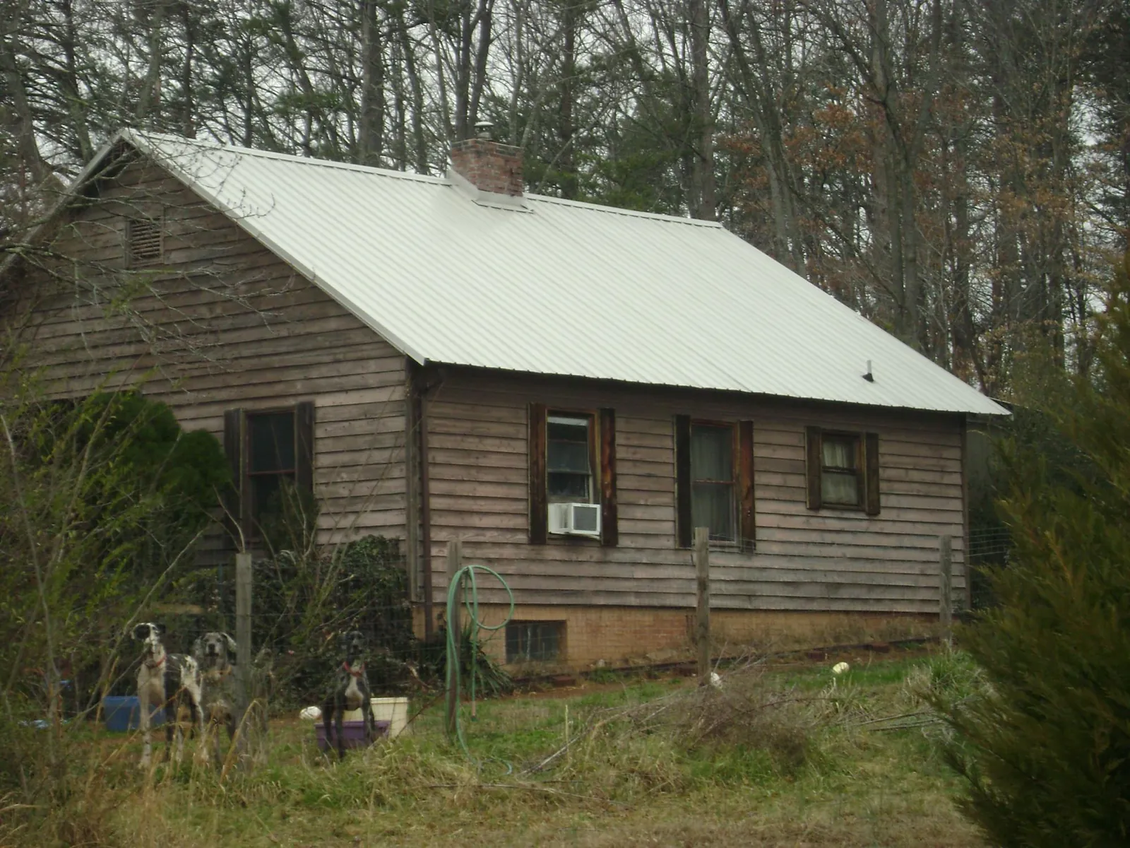 White metal roof on an old wood sided farmhouse, from a Metal Roof Installation job in Foxburg